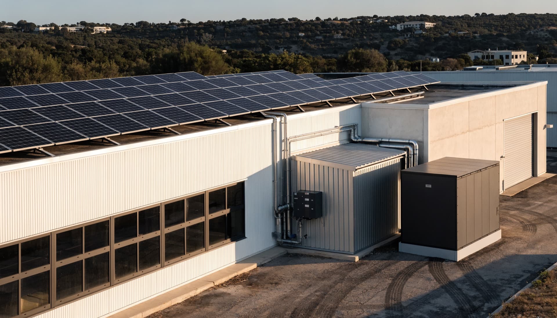 Commercial building with rooftop solar and outdoor battery enclosure